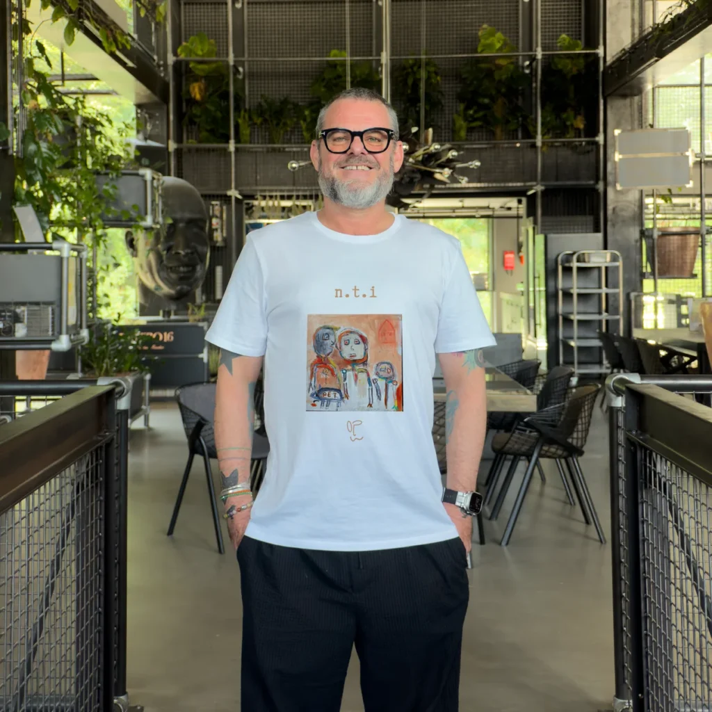 Model wearing a light blue t-shirt with a colourful character artwork print