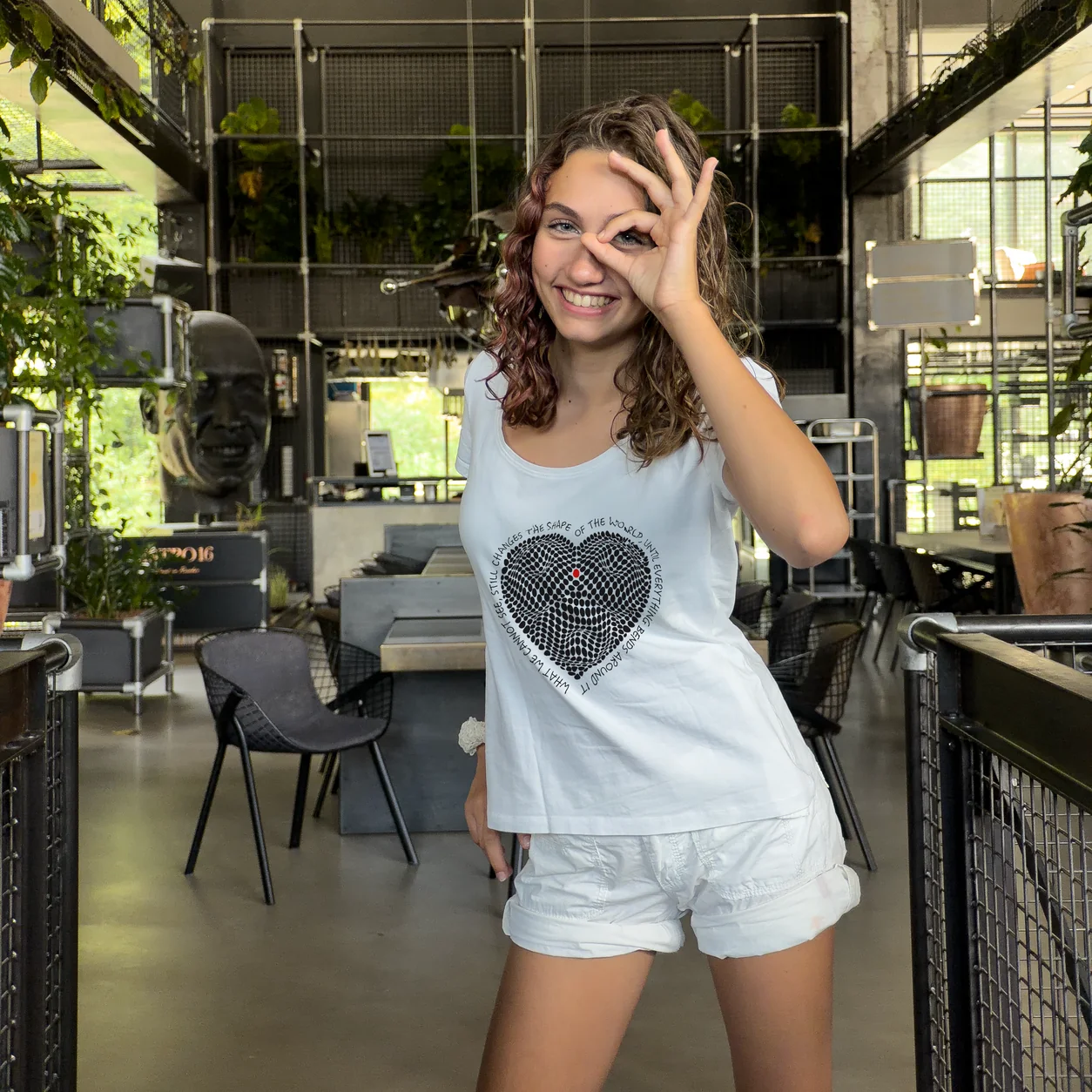Accomplice wearing a top with an artist design from The Invisible Plot — heart print
